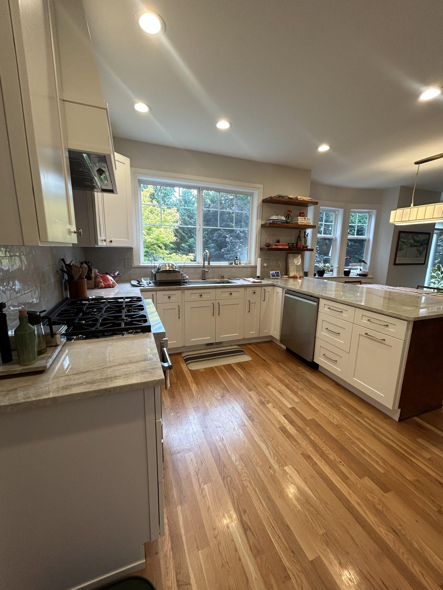 Open kitchen layout with refinished hardwood floors