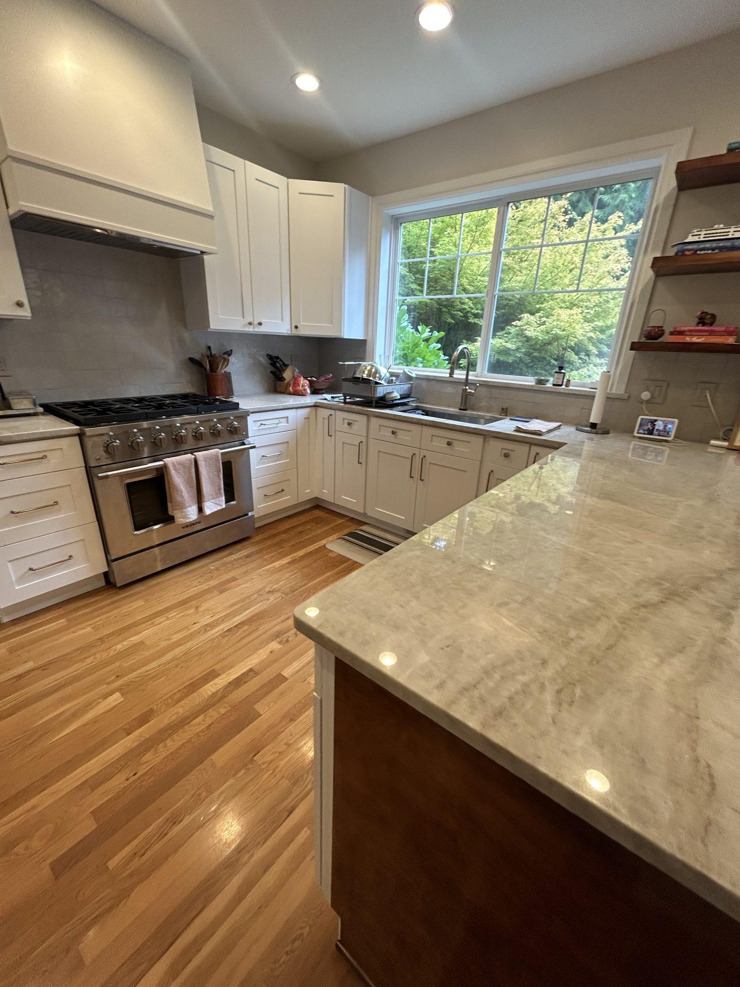Kitchen remodel with professional range and custom hood by Avalos Construction