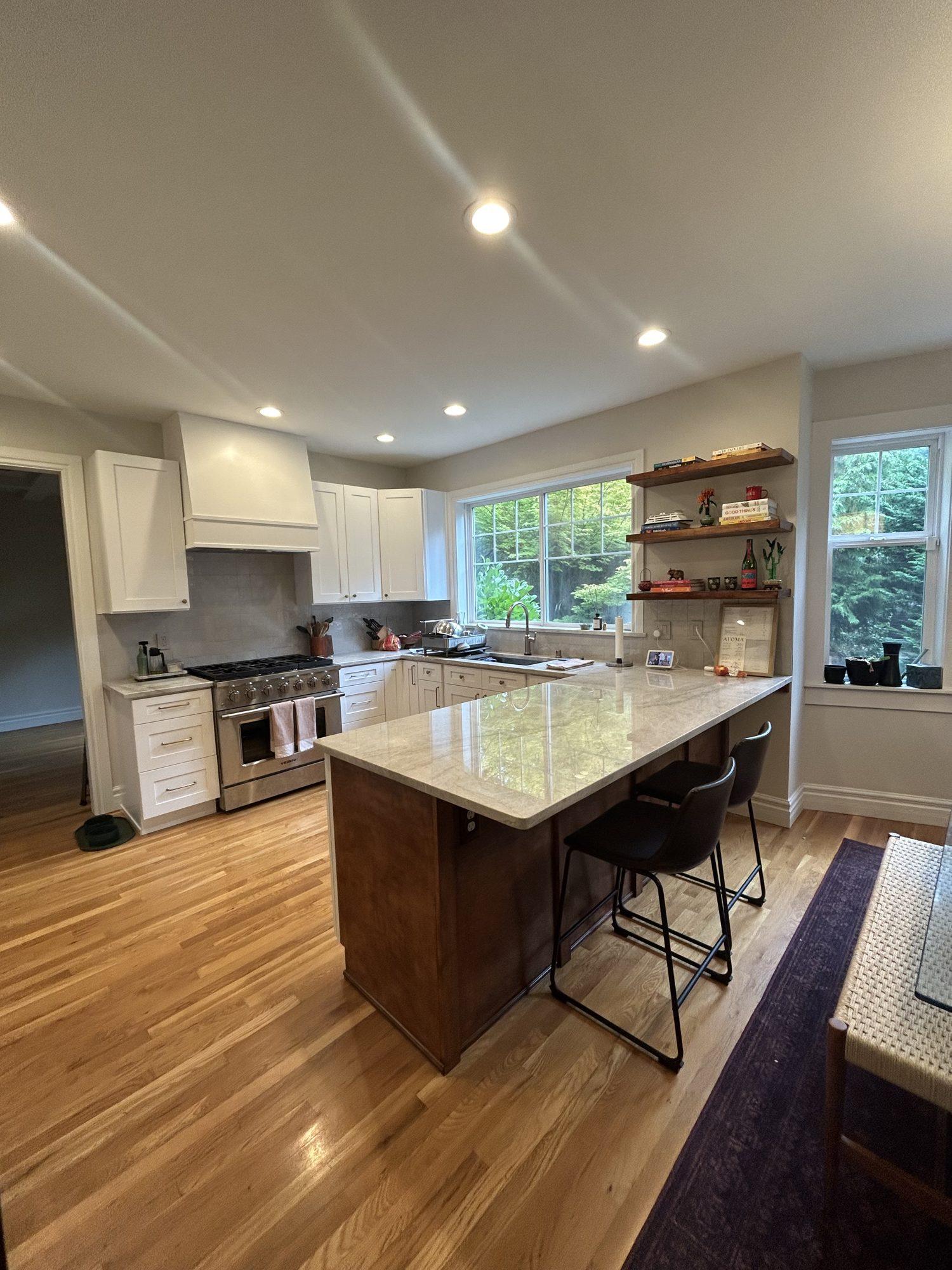Kitchen remodel with quartzite peninsula and white shaker cabinets